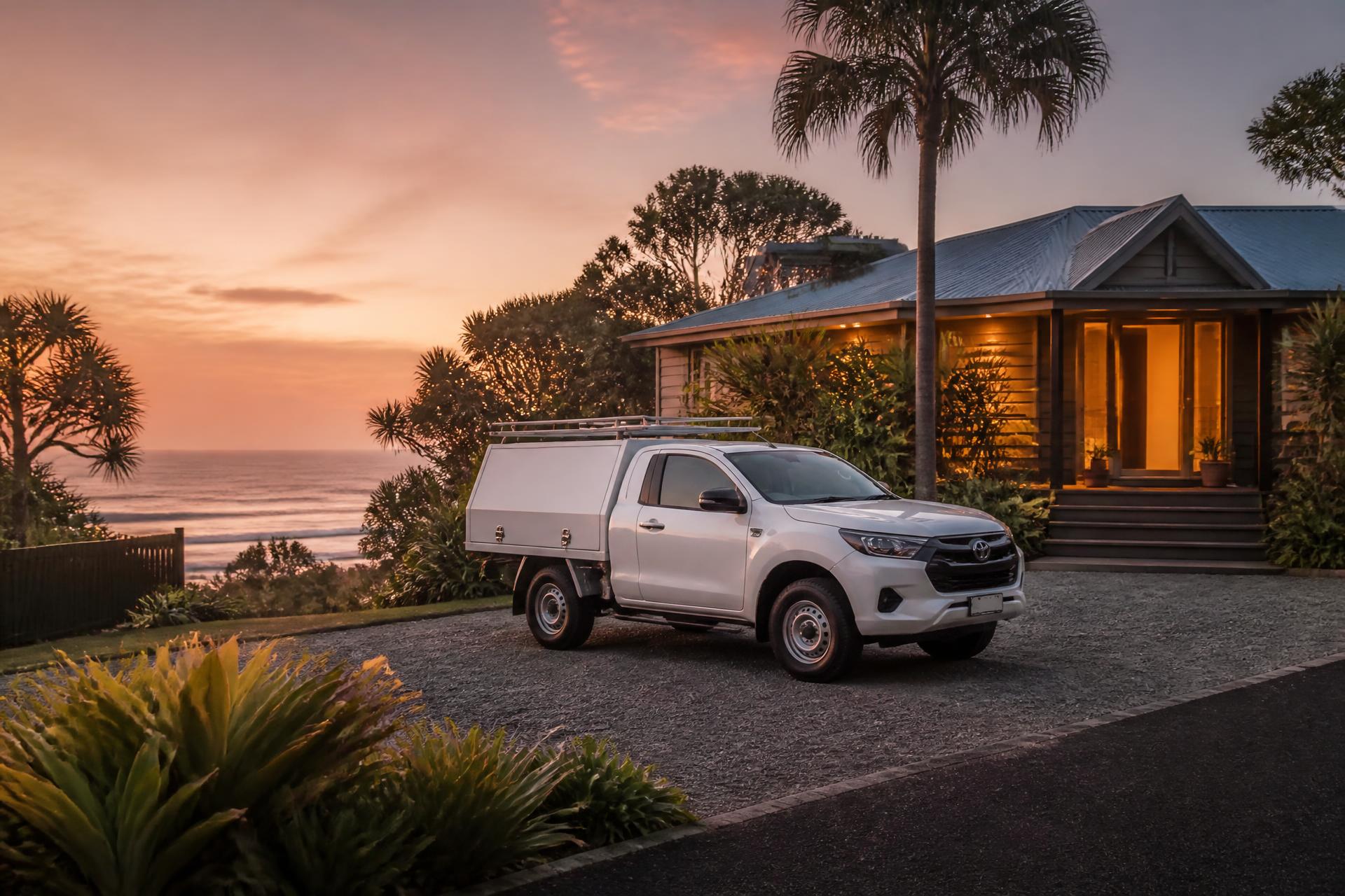 Service ute parked at a coastal Northern Rivers home at dusk, porch light on, same-day response on a Byron property